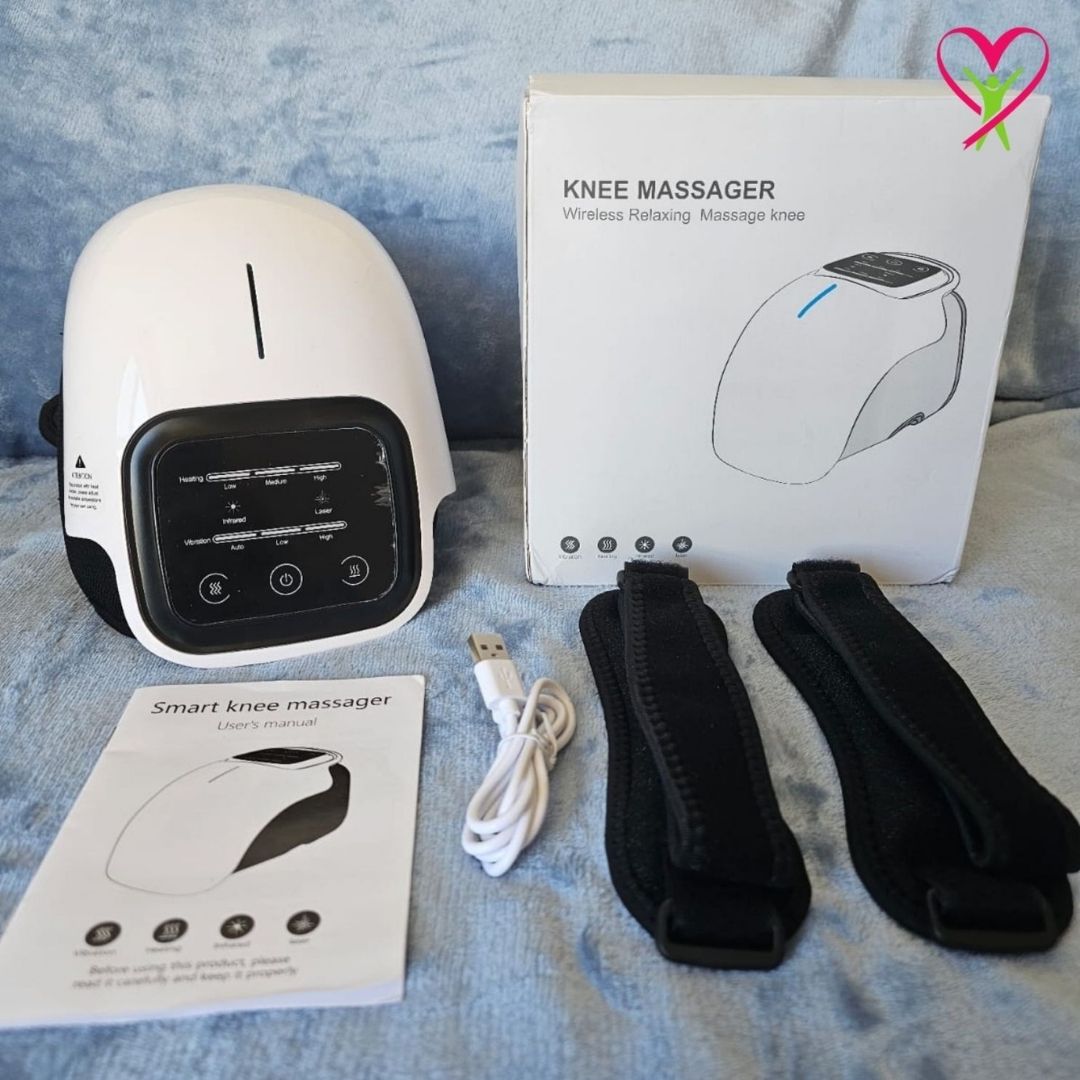 Smart knee massager with packaging, user manual, USB cable, and straps on a blue surface.